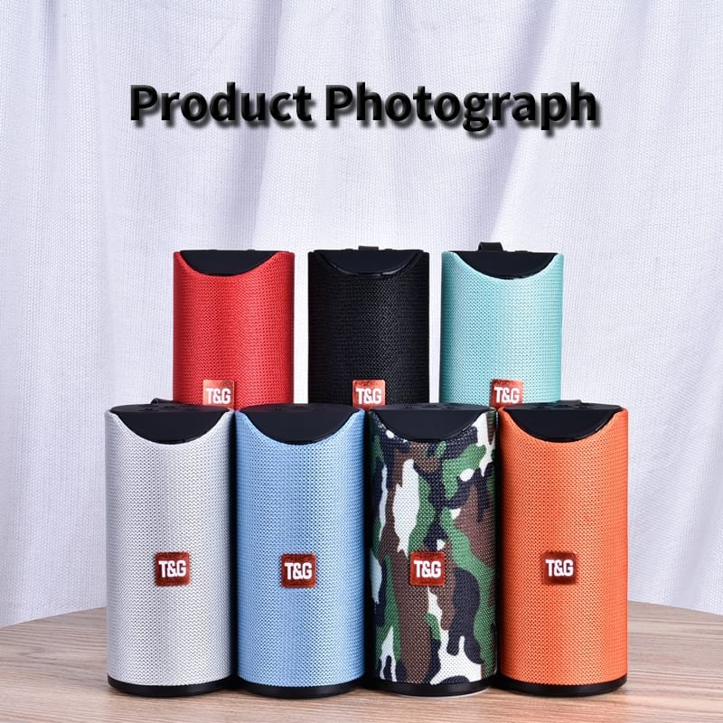 Collection of colorful T&G branded products on a wooden surface with a white curtain background.